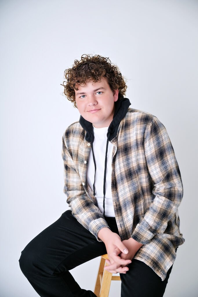 High School Senior Boy sitting on a stool